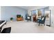 Living room bathed in sunlight with two blue chairs, carpet, and large windows at 13648 W 66Th Way, Arvada, CO 80004