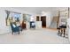 Bright living room with large windows, neutral carpet and staircase in view at 13648 W 66Th Way, Arvada, CO 80004