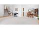 Spacious open-concept living area with a staircase, piano, and a dining area nearby at 13648 W 66Th Way, Arvada, CO 80004