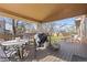 A covered patio with seating, grill and string lights at 13648 W 66Th Way, Arvada, CO 80004