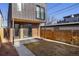 This modern backyard is a private retreat, featuring a small patio and wood privacy fence at 2230 W 36Th Ave, Denver, CO 80211