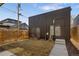 A fenced backyard offers privacy, featuring low maintenance landscaping and access to the home at 2230 W 36Th Ave, Denver, CO 80211