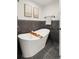 Elegant bathroom with a soaking tub, dark tile accent wall, and modern fixtures at 2230 W 36Th Ave, Denver, CO 80211