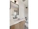 Bright bathroom features sleek black fixtures, shower, and a light wood vanity at 2230 W 36Th Ave, Denver, CO 80211