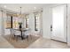 Bright dining room featuring a modern chandelier, large windows, and seating for four at 2230 W 36Th Ave, Denver, CO 80211