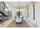 Elegant dining room showcasing a modern chandelier, large windows, and comfortable seating for six at 2230 W 36Th Ave, Denver, CO 80211