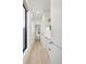 Bright hallway boasts hardwood floors, white walls, and access to the powder room at 2230 W 36Th Ave, Denver, CO 80211