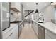 Modern kitchen featuring stainless steel appliances, white cabinets, and open layout at 2230 W 36Th Ave, Denver, CO 80211