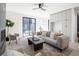 Bright living room boasts a ceiling fan, neutral color palette, and abundant natural light at 2230 W 36Th Ave, Denver, CO 80211