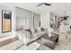 The living room is bright with light wood floors, a modern ceiling fan, and built in storage at 2230 W 36Th Ave, Denver, CO 80211