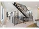 Bright and airy living room and kitchen featuring modern staircase, wood floors, and open concept design at 2230 W 36Th Ave, Denver, CO 80211