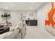 Modern living room featuring a gray couch, a small bar area with sink, and artistic decor at 2230 W 36Th Ave, Denver, CO 80211