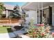 Cozy back patio with outdoor dining set, red roses, and view of the home's charming exterior at 1185 S Steele St, Denver, CO 80210