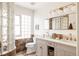 Bright, updated bathroom with double vanity, glass block privacy wall, and modern light fixtures at 1185 S Steele St, Denver, CO 80210