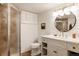 Updated bathroom featuring a glass shower, modern vanity with gold fixtures, and stylish lighting at 1185 S Steele St, Denver, CO 80210