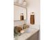 Stylish bathroom vanity featuring a quartz countertop, brass fixtures, and a modern framed mirror at 1185 S Steele St, Denver, CO 80210