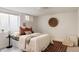Cozy basement bedroom with a neutral color scheme, comfortable bed, and a window with natural light at 1185 S Steele St, Denver, CO 80210