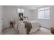Serene basement bedroom with plush bedding, natural light, and simple decor creating a restful retreat at 1185 S Steele St, Denver, CO 80210