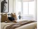 Bright bedroom with decorative pillows, a cozy throw, and a large bay window allowing ample natural light at 1185 S Steele St, Denver, CO 80210