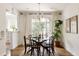 Bright dining room featuring a round table, modern chandelier, and large windows, perfect for Gathering gatherings at 1185 S Steele St, Denver, CO 80210