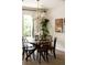 This dining room features a round wooden table, seating for six, and lots of natural light at 1185 S Steele St, Denver, CO 80210
