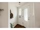 Entryway with decorative glass door, coat rack, and tiled floor at 1185 S Steele St, Denver, CO 80210
