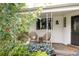 Inviting front porch with seating and decorative plants at 1185 S Steele St, Denver, CO 80210