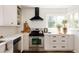 Well-lit kitchen featuring stainless steel appliances, ample counter space, and white cabinetry at 1185 S Steele St, Denver, CO 80210