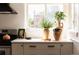 Bright kitchen detail featuring stainless steel oven, light countertops, and neutral cabinets at 1185 S Steele St, Denver, CO 80210