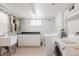 Bright laundry room with appliances, sink, countertop, and ample cabinet space at 1185 S Steele St, Denver, CO 80210