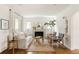 Bright living room featuring a fireplace, hardwood floors, and natural light at 1185 S Steele St, Denver, CO 80210