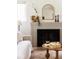 Cozy living room featuring a fireplace, round table, and decorative mantle at 1185 S Steele St, Denver, CO 80210
