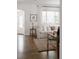 Living room with hardwood floors, white sofa, and doorway to front entry at 1185 S Steele St, Denver, CO 80210