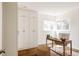 Bright home office with built-in storage, a wooden desk, and a comfortable woven chair at 1185 S Steele St, Denver, CO 80210