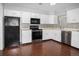 Kitchen with stainless appliances, white cabinets, and modern backsplash at 3600 S Pierce St # 2-201, Lakewood, CO 80235