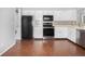 Kitchen with stainless appliances, white cabinets, and modern backsplash at 3600 S Pierce St # 2-201, Lakewood, CO 80235