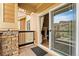 Balcony with view into living room with fireplace through sliding glass door at 8779 S Kipling Way # 204, Littleton, CO 80127