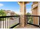 Balcony with stone support beams overlooking neighborhood street with trees at 8779 S Kipling Way # 204, Littleton, CO 80127