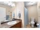 Bathroom featuring a single vanity, mirror and shower with blue curtain at 8779 S Kipling Way # 204, Littleton, CO 80127