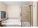 Bathroom shows bathtub and shower with glass enclosure, along with blue towels at 8779 S Kipling Way # 204, Littleton, CO 80127