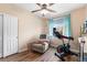Bedroom with exercise equipment, recliner, ceiling fan, and a closet at 8779 S Kipling Way # 204, Littleton, CO 80127