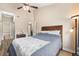 Spacious bedroom with wood floors, ceiling fan, a bed and ensuite bathroom access at 8779 S Kipling Way # 204, Littleton, CO 80127
