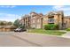 Beautiful condominium exterior featuring balconies, attached garage, and manicured landscaping at 8779 S Kipling Way # 204, Littleton, CO 80127