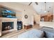 Cozy living room features a fireplace, high ceilings, and open access to the kitchen at 8779 S Kipling Way # 204, Littleton, CO 80127