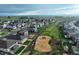 A neighborhood aerial view highlights a playground and community green space at 2303 Monte Vista St, Fort Lupton, CO 80621