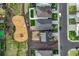 This aerial view shows a playground, homes and a street with cars at 2303 Monte Vista St, Fort Lupton, CO 80621