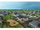 Discover a vibrant neighborhood, featuring playgrounds and landscaped yards, from an aerial view at 2303 Monte Vista St, Fort Lupton, CO 80621