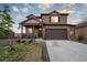 Beautiful two-story home features a two-car garage, a quaint front porch, and easy-to-maintain landscaping at 2303 Monte Vista St, Fort Lupton, CO 80621
