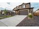 Two-story home showing a two-car garage, a concrete driveway, and easy-to-maintain landscaping at 2303 Monte Vista St, Fort Lupton, CO 80621