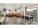 Open-concept living room with hardwood floors, a dining table and a comfortable seating area at 2303 Monte Vista St, Fort Lupton, CO 80621
